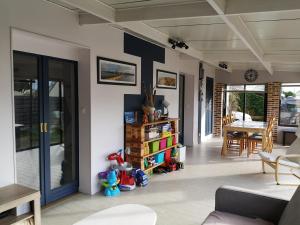 a living room with a couch and a table at Holiday Home Maison de l'Océan à Denneville in Denneville