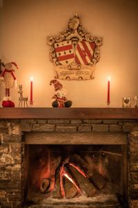 a fireplace with two candles on top of it at Hostal Crisami in Solsona