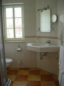 a bathroom with a sink and a toilet at Hotel Weidenmühle in Mühlhausen