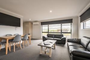 a living room with a couch and a table at Seabrook Hotel in Somerset