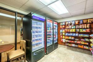 a grocery store with a refrigerator and shelves of food at Ramada by Wyndham North Platte in North Platte