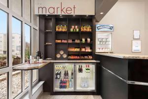 a market store with a counter with a refrigerator at Ramada by Wyndham Bottrop City in Bottrop