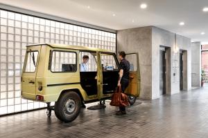 a man is getting into a yellow truck at Veriu Green Square in Sydney