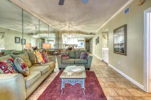 a living room with a couch and a table at Enclave 605 in Orange Beach