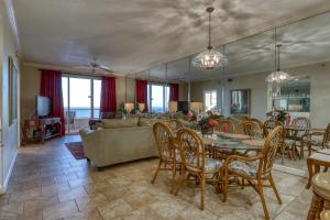 a dining room and living room with a table and chairs at Enclave 605 in Orange Beach