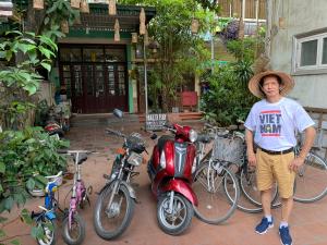 a man is standing next to a group of bikes at Halo Bay Homestay in Ha Long
