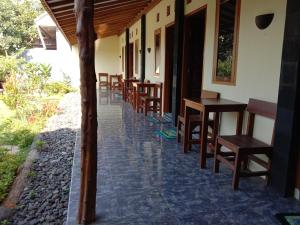 a row of tables and chairs on a patio at Sunrise Banyuwangi Homestay in Banyuwangi