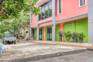 a building with green and colorful walls at RedDoorz near Taman Mini Jakarta in Jakarta