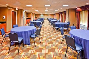 a row of tables and chairs in a room at Holiday Inn Express Hotel & Suites Memphis/Germantown by IHG in Memphis