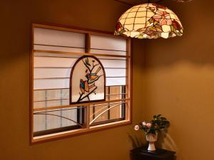 a stained glass window with a bird on a branch at Hotel Hagoromo in Shizuoka