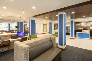 a lobby of a hospital with a couch and chairs at Holiday Inn Express Hotel & Suites Detroit-Utica by IHG in Utica