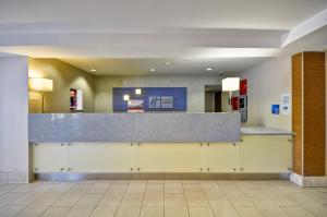 a lobby of a hospital with a counter at Holiday Inn Express Romulus / Detroit Airport, an IHG Hotel in Romulus