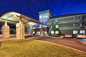 a hotel with a gas station at night at Holiday Inn Express Romulus / Detroit Airport, an IHG Hotel in Romulus