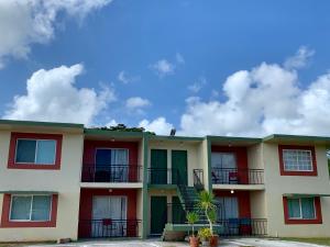 an apartment building with red and yellow at Casa De Pedro- Entire Villa in Mangilao