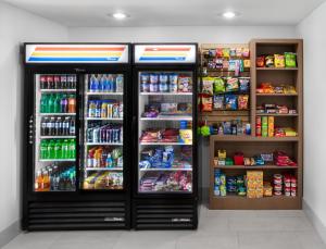 two refrigerators in a store with drinks and food at Holiday Inn Express Hotel & Suites Altoona-Des Moines, an IHG Hotel in Altoona