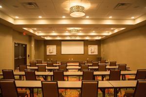 a conference room with tables and chairs and a whiteboard at Holiday Inn Murfreesboro by IHG in Murfreesboro +62 photos
