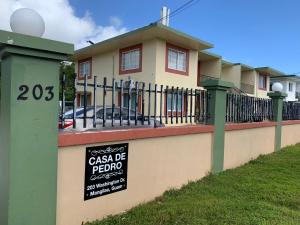 a house with a sign in front of it at Entire Private Villa- Casa De Pedro in Mangilao