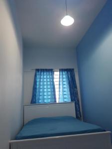 a small room with a bed and a window at The Sky - The Cave Guest House in Tanah Rata
