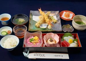 a tray of food with seafood and other dishes at Shinwaka Lodge in Wakayama
