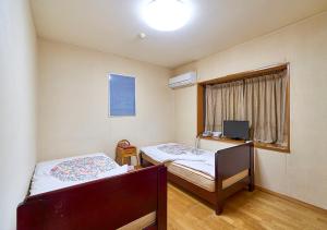 Postel nebo postele na pokoji v ubytování Shinwaka Lodge