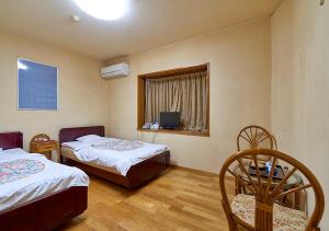 Postel nebo postele na pokoji v ubytování Shinwaka Lodge