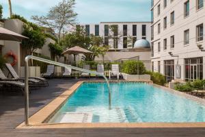 a swimming pool with a water fountain at Holiday Inn Express Durban - Umhlanga by IHG in Durban