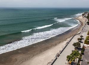 a beach with a large body of water at Crowne Plaza Hotel Ventura Beach, an IHG Hotel in Ventura