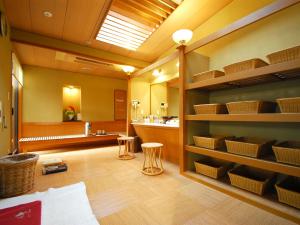 a bathroom with a sink and a counter with baskets at Hotel Hagoromo in Shizuoka