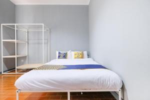 a bedroom with a bed and a book shelf at SPOT ON 2281 Omajo in Semarang