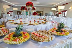 a long table with many plates of food on it at Hotel Bonsai in Niemcza