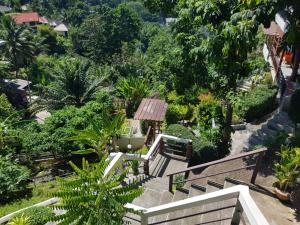 a garden with benches and trees at Balcony Villa in Koh Tao