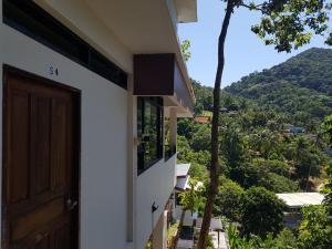 a door to a house with a view of a mountain at Balcony Villa in Koh Tao