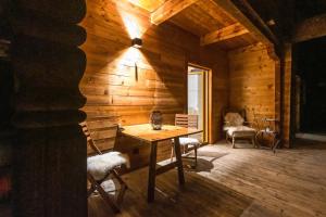 a wooden room with a wooden table and chairs at Apartment Haus Schönwies in Alpbach