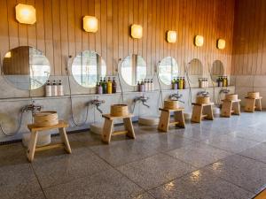 a bathroom with a row of sinks and mirrors at Hotel Hagoromo in Shizuoka