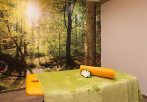 a table with an orange chair in front of a painting at Unterthurnerhof in Rifiano +37 photos