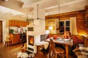 a man and woman in a living room with a fireplace at Das Schierke Harzresort in Schierke