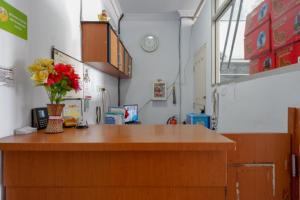 a room with a counter with a vase of flowers on it at RedDoorz @ Hotel Bravo Pantai Kamali Bau Bau in Baubau