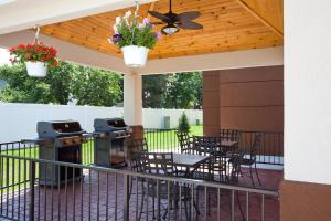 a patio with tables and chairs and a grill at Candlewood Suites Dickinson by IHG in Dickinson