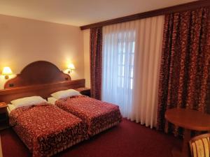 Ein Bett oder Betten in einem Zimmer der Unterkunft Hotel Amalia