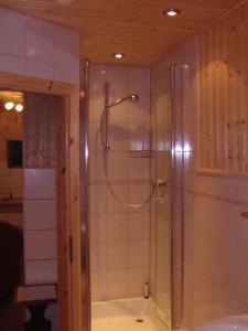 a bathroom with a shower with a glass door at Halmis FeWo in Derenburg