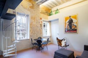 a room with a table and chairs and a staircase at Casatorre dei Leoni Dimora Storica in Siena