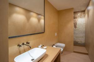 a bathroom with a sink and a toilet at Casatorre dei Leoni Dimora Storica in Siena