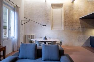 a living room with a table and chairs at Casatorre dei Leoni Dimora Storica in Siena