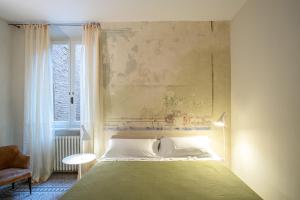 a bedroom with a large bed and a window at Casatorre dei Leoni Dimora Storica in Siena