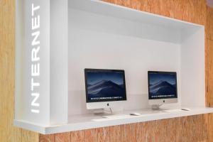 two computer monitors on a shelf on a wall at Holiday Inn Express Taichung Fengchia, an IHG Hotel in Taichung