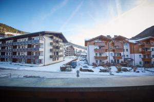 a group of buildings with snow on the ground at Appartement White Chili in Saalbach Hinterglemm