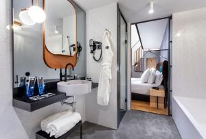 a bathroom with a sink and a mirror at One Shot Tabakalera House in Donostia-San Sebastián