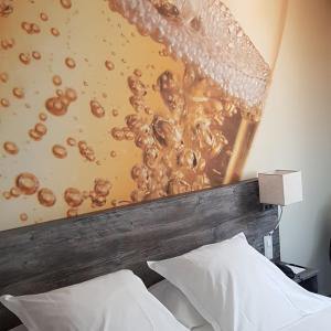 a headboard of a bed with a wall with bubbles at Hotel de Champagne in Épernay