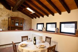 a dining room with a table and chairs and windows at Castello Oldofredi in Monte Isola