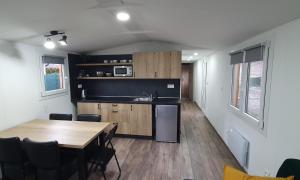 a kitchen and dining room with a table in a room at Liptov Mobile House in Liptovský Mikuláš